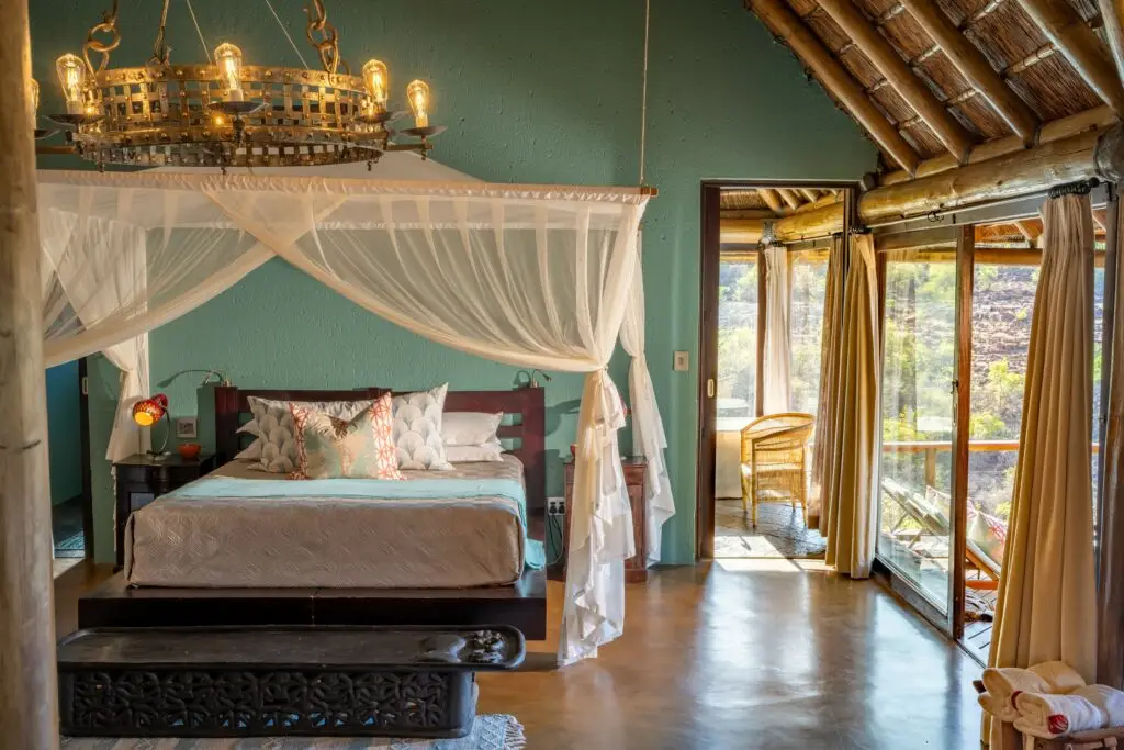 The primary bedroom in a luxury suite at Sediba Safari Lodge