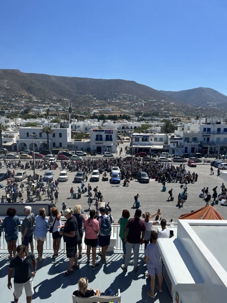 People waving from a ferry in Greece to the people on the port