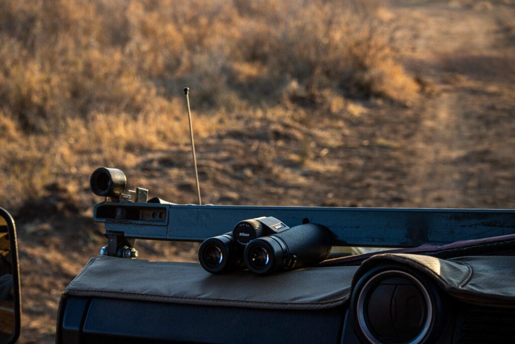 A pair of binoculars on the dash of a game vehicle