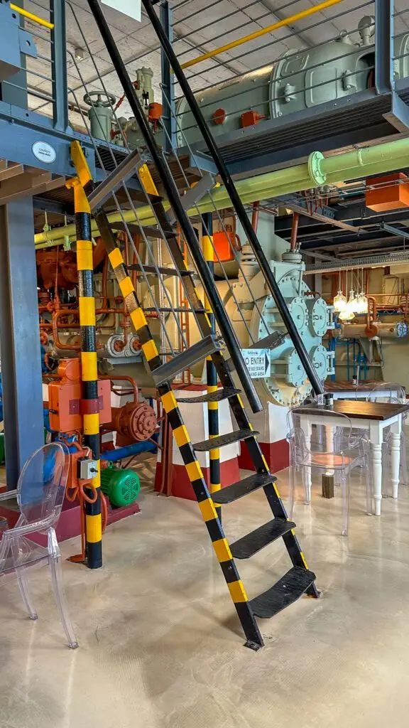 The whimsical interior of the Turbine Hotel. The old turbine engines and equipment is painted in bright colours to create a chic and modern atmosphere