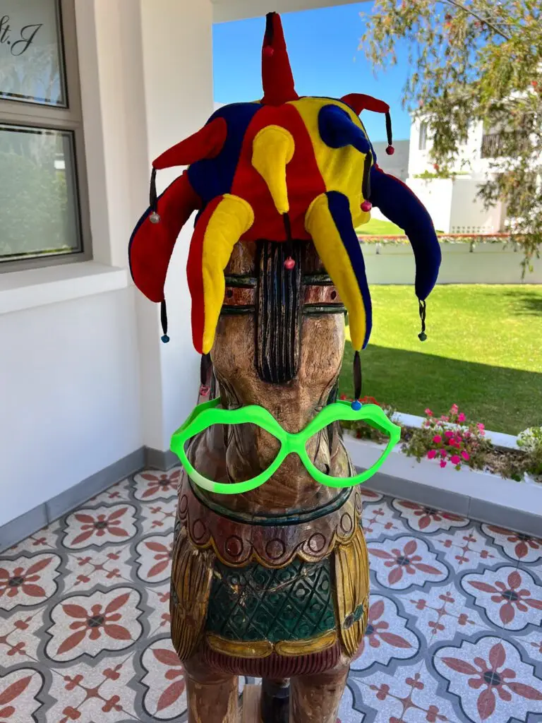 A wooden horse with a hat on