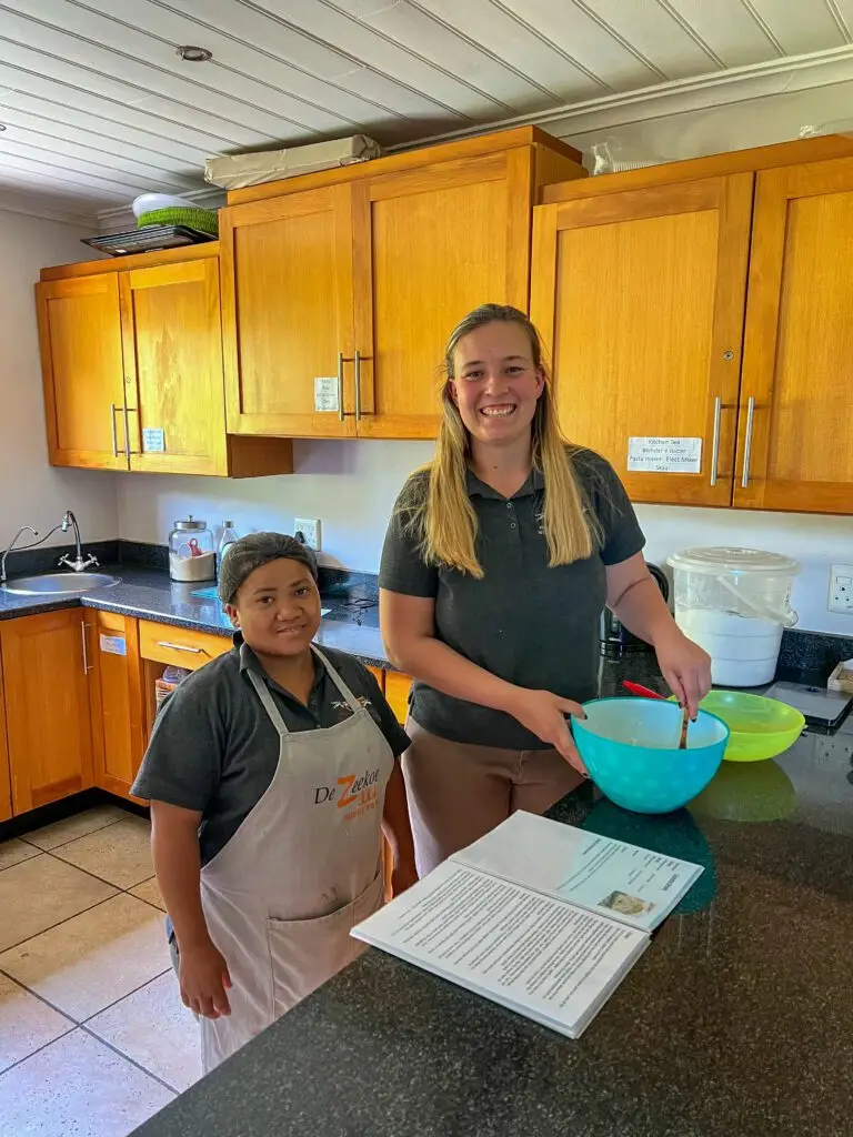 Staff members working in the kitchen baking a bread