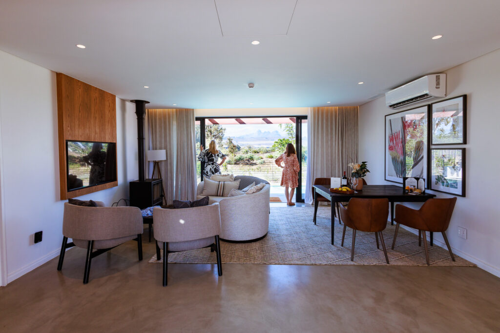 The lounge area opening up to the heated pool of one the Luxury Cottages at Vergenoegd Löw Boutique Hotel and Spa