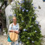 Lady in a dress in front of flowers