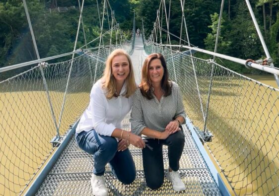 two women on bridge over river. Iller Brücke. How to start a travel blog