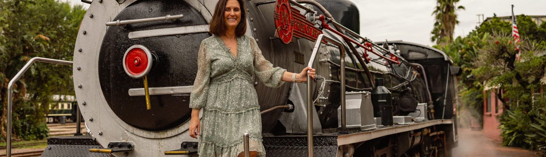 Petra standing on the steam locomotive of Rovos Rails