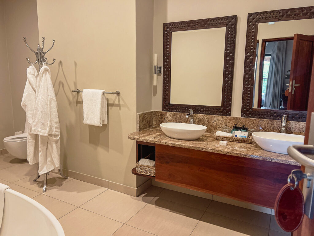 Our lovely appointed bathroom with double vanities and large walk-in rain shower